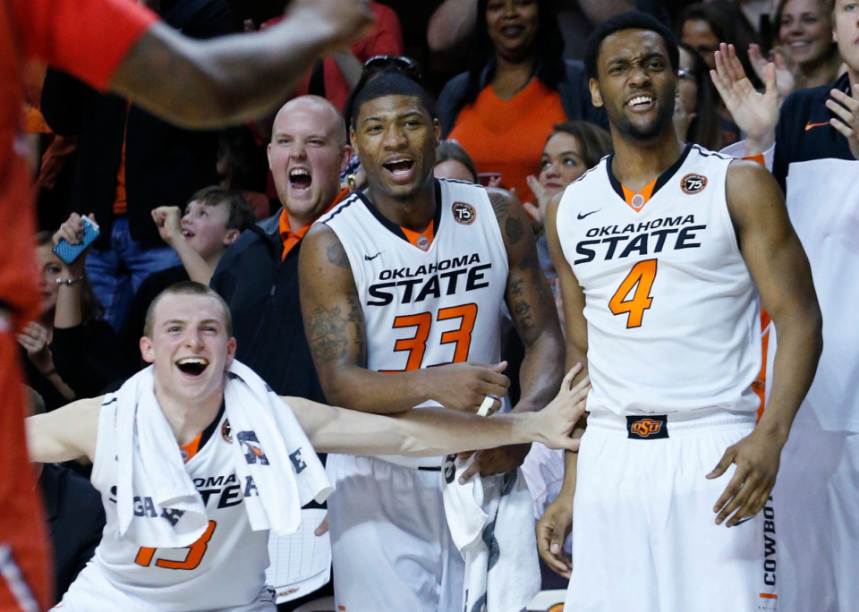 <strong>Oklahoma State guard Phil Forte (13), guard Marcus Smart (33) and wing Brian Williams (4) cheer on the bench following a dunk by teammate Le'Bryan Nash in the second half of an NCAA college basketball game against Texas Tech in Stillwater, Okla., Saturday, Feb. 22, 2014.</strong> (Sue Ogrocki/AP file)