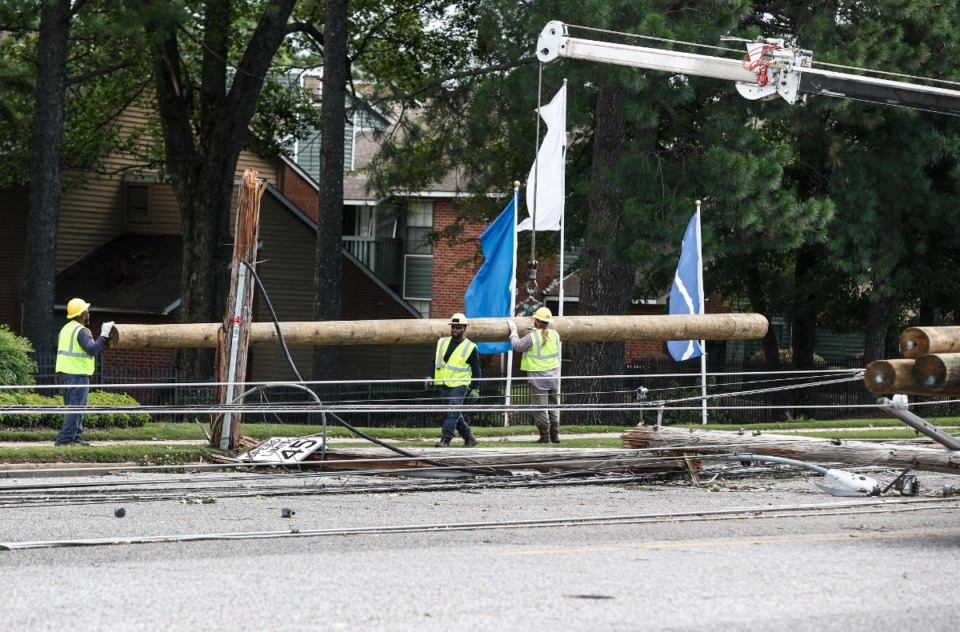 <strong>Memphis Light, Gas and Water crews work to restore power to several downed electrical lines on Winchester Road near Ross Road July 19.</strong> (Mark Weber/The Daily Memphian)