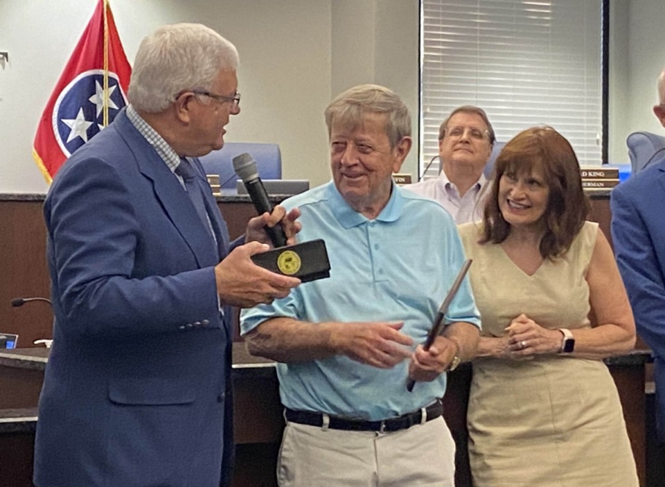 <strong>Mayor David Parsons (left) gives a key to the city to outgoing Alderman Bobby Simmons (middle). Simmons' wife Sherry stands at right.</strong> (Michael Waddell/The Daily Memphian)