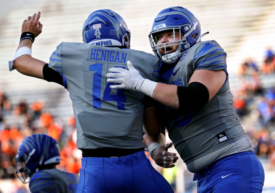 <strong>University of Memphis quarterback Seth Henigan (14) celebrates with Jacob Likes (70) after a touchdown during a Sept. 25, 2021 game against University of Texas San Antonio at the Liberty Bowl Memorial Stadium in Memphis, Tennessee.</strong> (Patrick Lantrip/The Daily Memphian file)