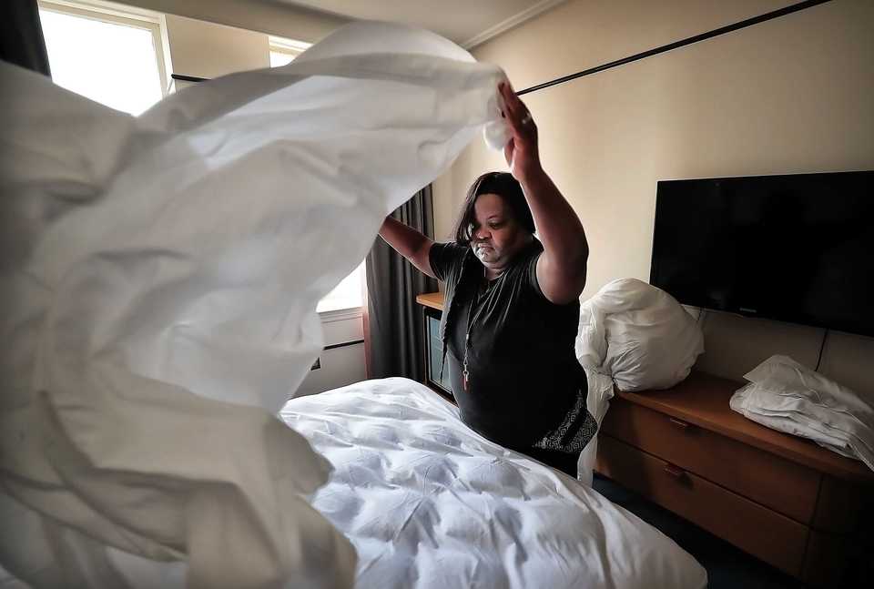 <strong>Tracey Buckner replaces the linens in one of the standard rooms at the newly rebranded Hu. Hotel on Oct. 11, 2018. The new Aparium hotel replaces the former Madison while adding a few upgrades including the Hu. Diner and an indoor/outdoor restaurant on the roof.</strong> (Jim Weber/Daily Memphian)