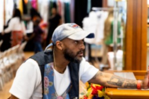 <strong>Memphis-born fashion designer Prep Curry speaks to the audience during a fashion show Sunday at the Shops of Saddle Creek.</strong> (Brad Vest/Special to The Daily Memphian)