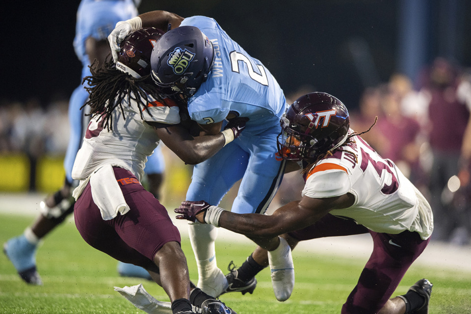 <strong>Old Dominion running back Blake Watson (2) is brought down by Virginia Tech defensive back Nasir Peoples (5) and linebacker Jayden McDonald (38) during the first half of an NCAA college football game Friday, Sept. 2, 2022, in Norfolk, Va. Last season,&nbsp;Watson suffered an injury in the middle of spring practices.</strong>&nbsp;(Mike Caudill/AP Photo file)