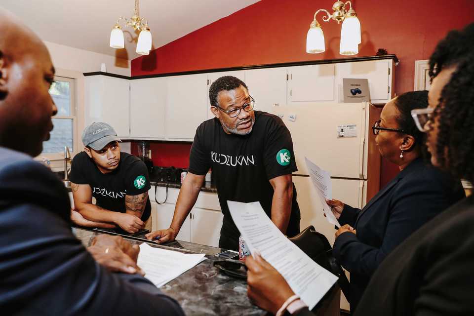<strong>Larry Robinson (center), founder of Kudzukian, goes through the Grindset podcast script with guest Carlee McCullough (right), of McCullough Law Group. Robinson produces the podcast from the Kudzukian studio at 2189 Monore Ave.</strong> (Houston Cofield/Daily Memphian)