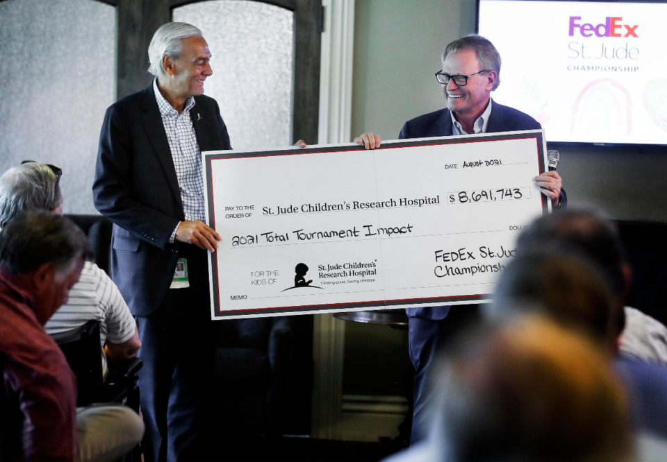 <strong>Rick Shadyac, president and CEO of ALSAC (left) receives a check from Jack Sammons for over $8.6 million on Thursday, June 16, 2022, that the FedEx St. Jude Championship raised last year.</strong> (Mark Weber/The Daily Memphian file)