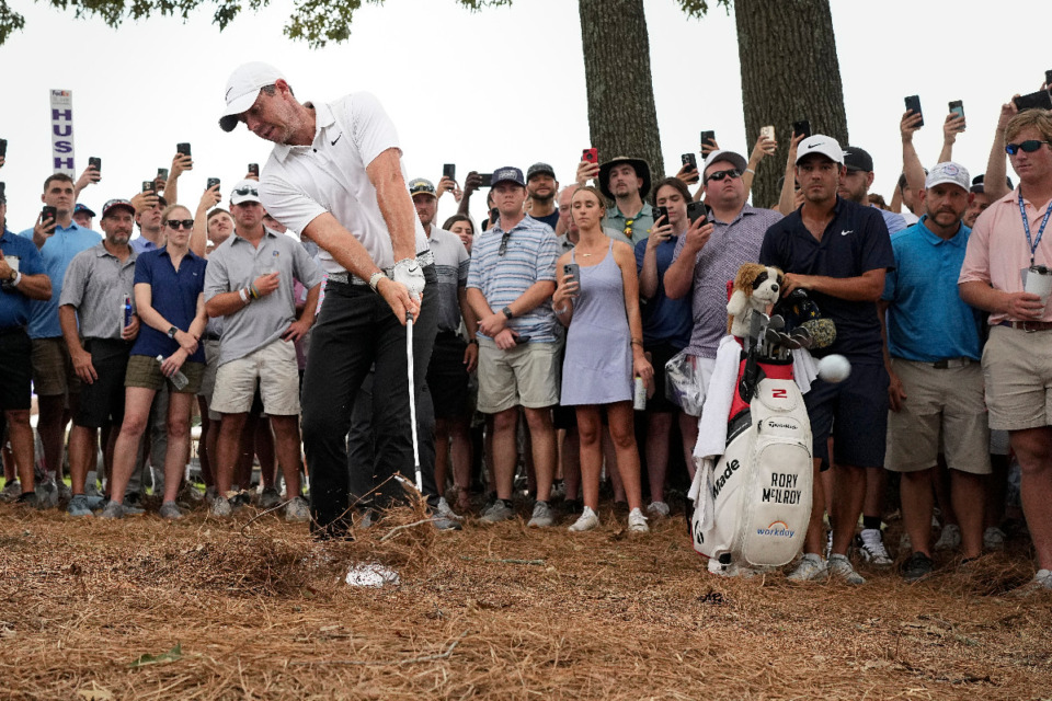 <strong>Rory McIlroy hits from the pine straw on the 18th hole during the third round of the FedEx St. Jude Championship golf tournament Saturday, Aug. 12, 2023.</strong> <strong>McIlroy&rsquo;s caddie took his putter to Edwin Watts for repairs on Friday night.</strong> (AP Photo/George Walker IV)