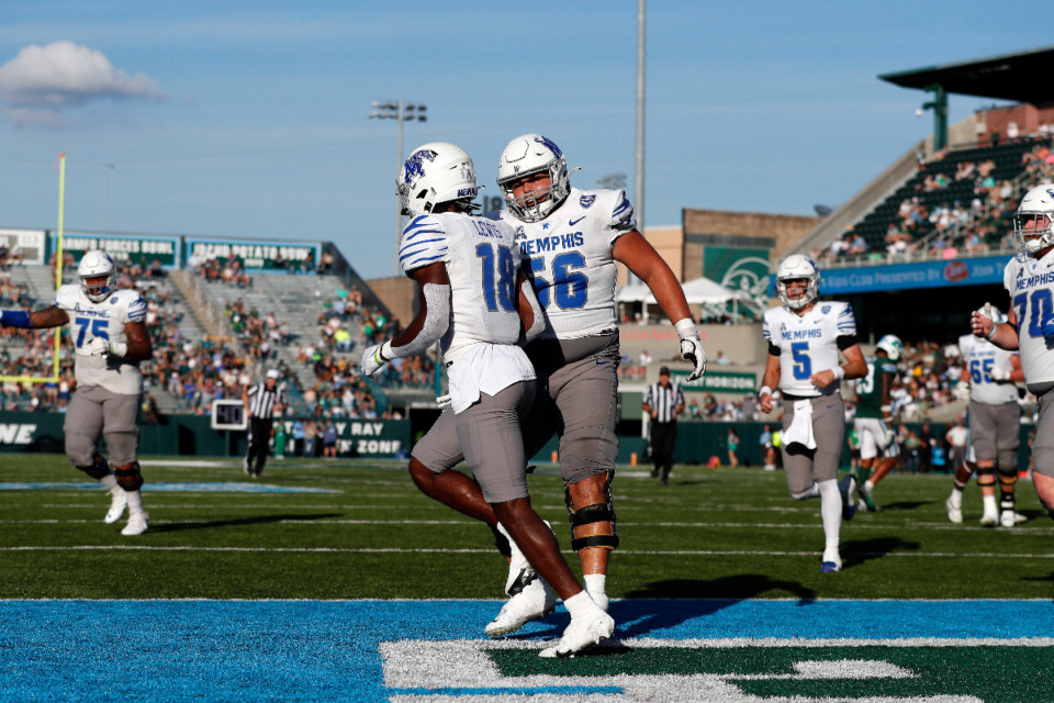 <strong>Memphis offensive lineman Davion Carter (56) and wide receiver Eddie Lewis (18) celebrate after a touchdown during the second half of a game against Tulane in New Orleans Oct. 22, 2022.</strong> (Tyler Kaufman/AP Photo file)