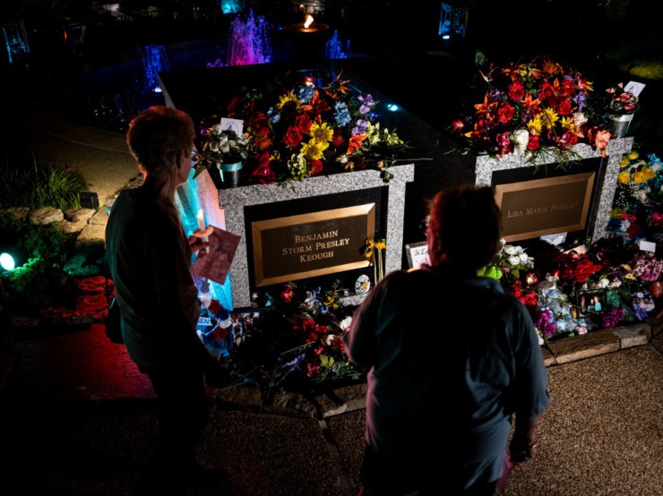 <strong>Fans pass by Elvis' gravesite at the Candlelight Vigil at Graceland Aug. 15.&nbsp;</strong>(Brad Vest/Special to The Daily Memphian)