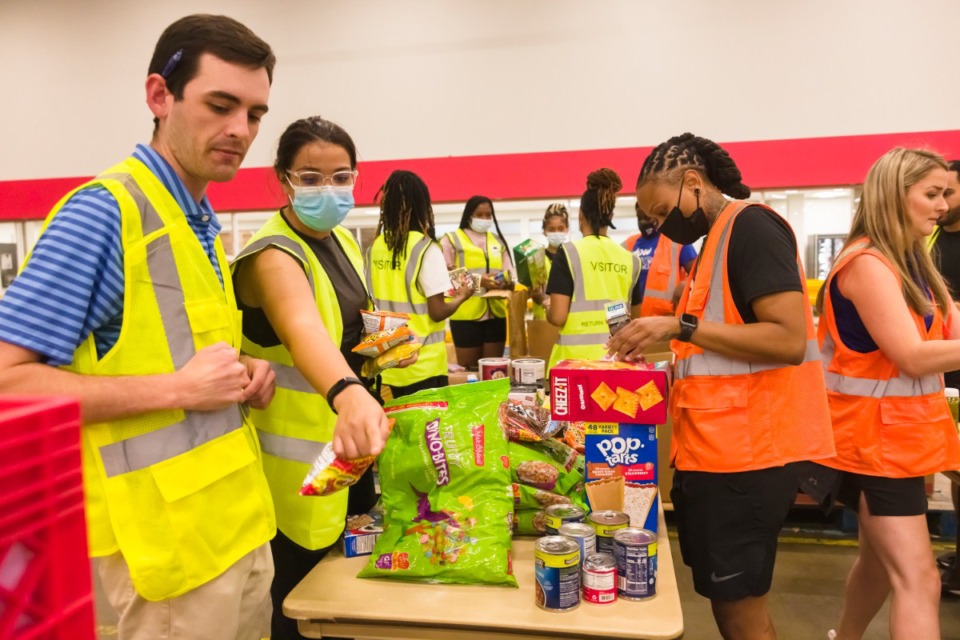 <strong>Members of the University of Memphis Athletic Department pitch in Thursday, July 21, 2022 at Mid-South Food Bank.</strong> (Ziggy Mack/Special to The Daily Memphian file)