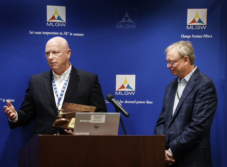 <strong>Memphis Light, Gas and Water President and CEO Doug McGowen (left) honors MLGW board chair Mitch Graves (right) during a meeting on Dec. 21, 2022.</strong> (Mark Weber/The Daily Memphian file)