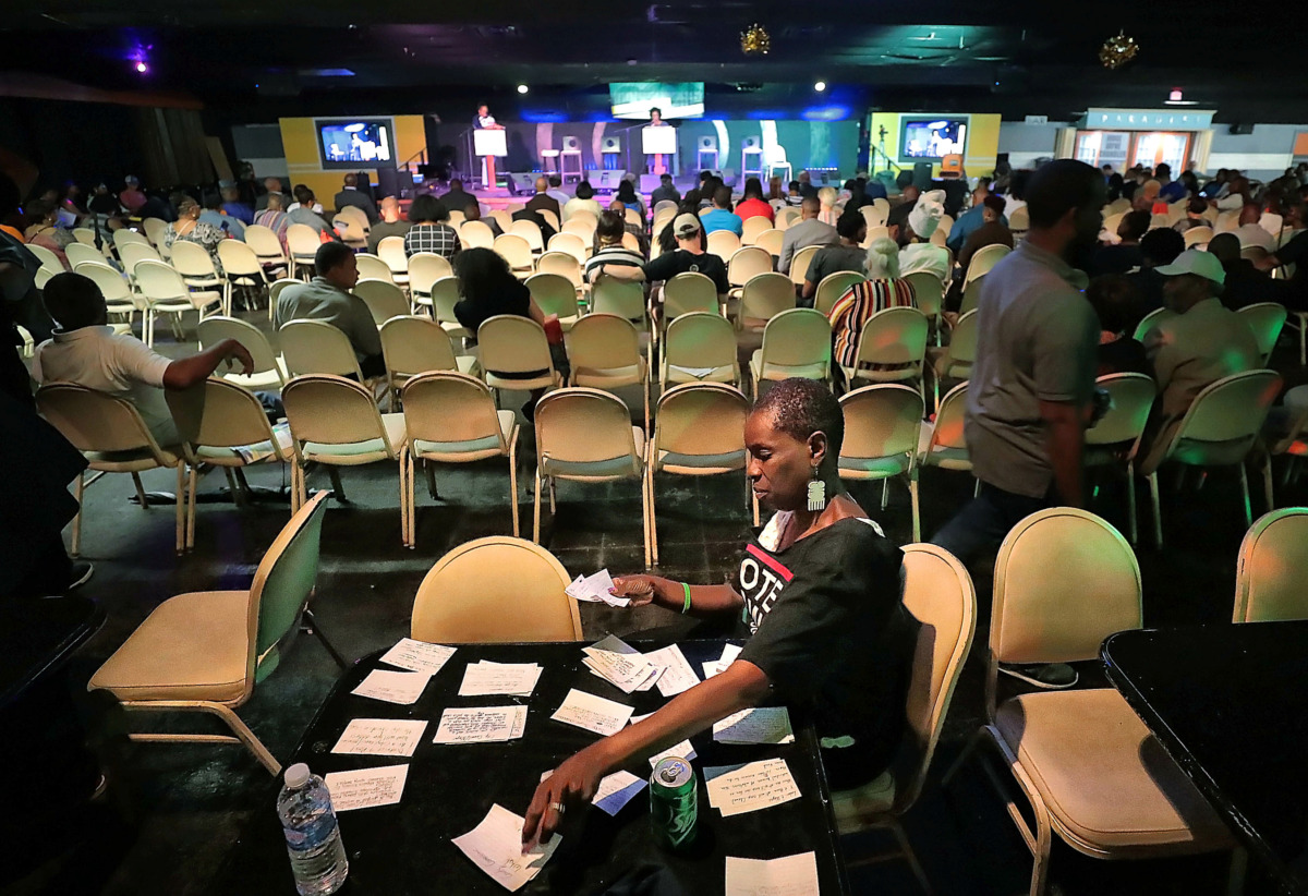 <strong>Volunteer Regina Clarke sorts through questions for the candidates during the People's Convention on June 8, 2019, at the Paradise Entertainment Center.</strong> (Jim Weber/Daily Memphian)