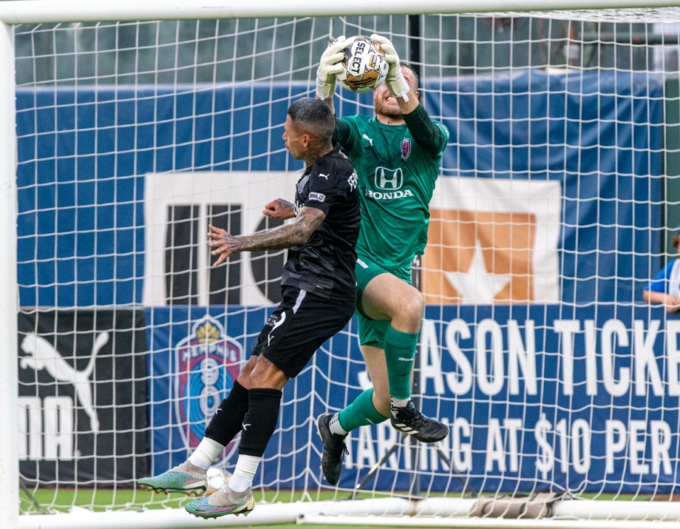 <strong>Midfielder Luiz Fernando tries to head the ball into the goal as Indy Eleven goalkeeper Tim Trilk catches it during Wednesday's match at AutoZone Park. The game ended in a 0-0 tie.</strong> (Greg Campbell/Special to The Daily Memphian)