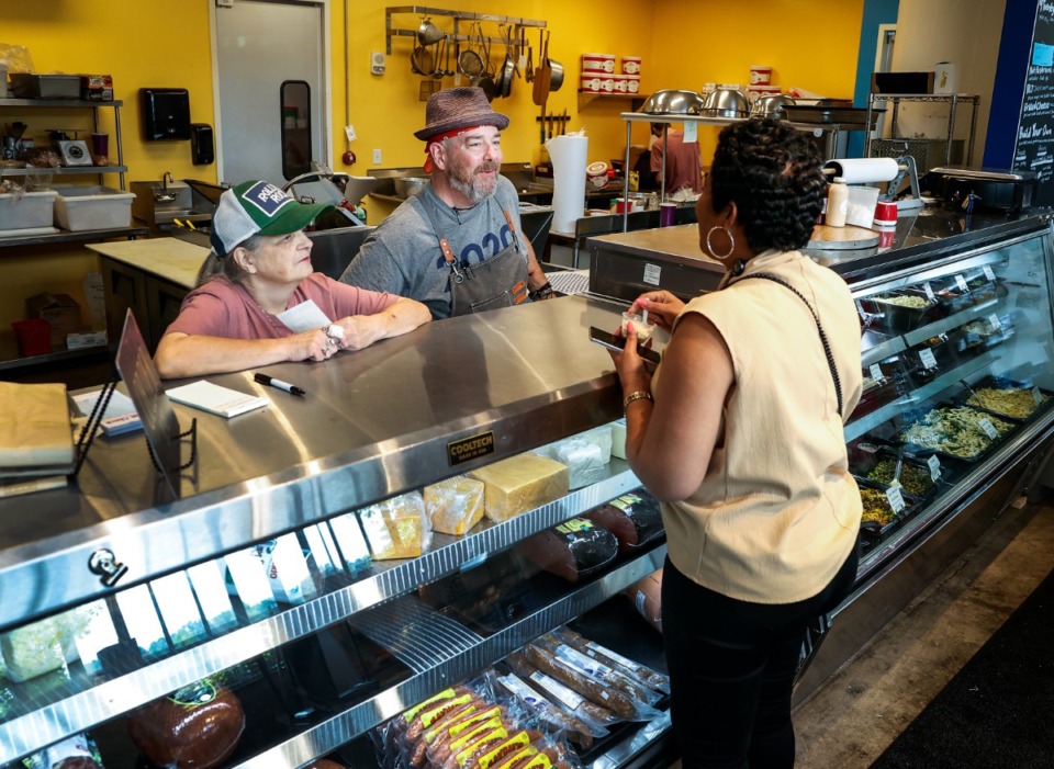 <strong>Mad Grocer co-owner Max Hussey (middle) chats with a customer on Thursday, Aug. 24, 2023.</strong> (Mark Weber/The Daily Memphian)