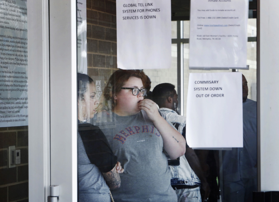 <strong>Sam Gloff (middle) waits inside the Shelby County Jail after being told the video visitation system was down and she would not be able talk with her friend on Monday, June 10. Officials said they hope the video system is back up by Friday.</strong> (Mark Weber/Daily Memphian)