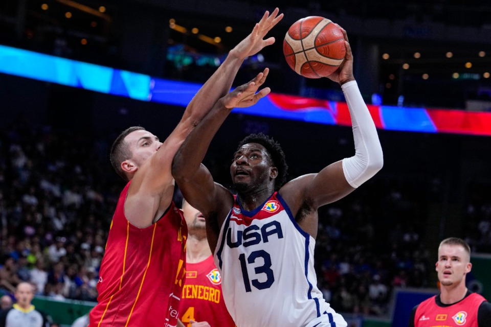 <strong>U.S. forward Jaren Jackson Jr. (13) shoots over Montenegro center Marko Simonovic (19) during the second half of a Basketball World Cup second round match in Manila, Philippines Friday, Sept. 1, 2023.</strong> (AP Photo/Michael Conroy)