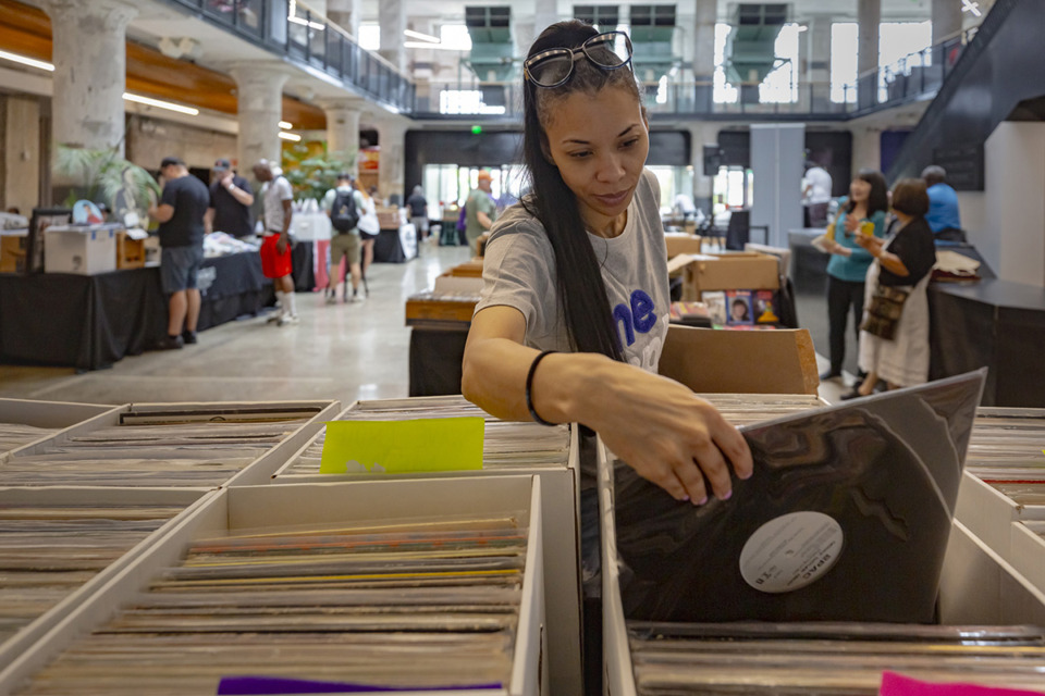 <strong>Nia Hughes digs through crates of vinyl records during the Record Swap at Crosstown Concourse Sept. 3.</strong> (Ziggy Mack/Special to The Daily Memphian)