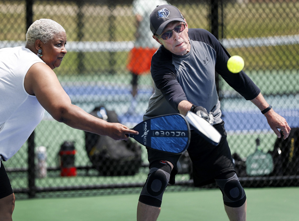 <strong>The Campbell Clinic Foundation has launched a scientific study on local pickleball players. Darnella Bennett (left) and Rex Brown (right) reach for the ball while playing on the Bartlett pickleball courts in 2021 in Shadowlawn Park.</strong> (Mark Weber/The Daily Memphian file)