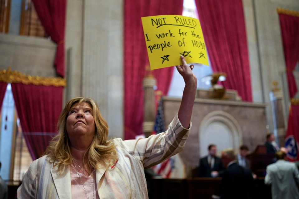 <strong>Rep. Gloria Johnson, D-Knoxville, holds a sign on the House floor after a special session of the state legislature on public safety adjourned Tuesday, Aug. 29, 2023, in Nashville, Tenn.</strong> (AP Photo/George Walker IV)