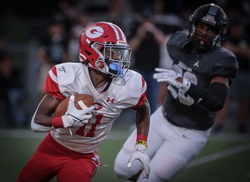<strong>Germantown receiver Jaden Jones (11) runs the ball against Houston Sept. 1. The Red Devils are still unbeaten as they prepare to face Murfreesboro Riverdale Sept. 8.</strong> (Patrick Lantrip/The Daily Memphian file)