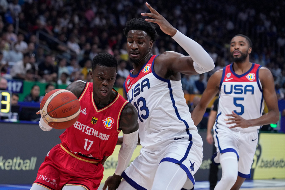 <strong>Germany guard Dennis Schroder, left, goes around U.S. forward Jaren Jackson Jr. during a Basketball World Cup semi final game in Manila, Philippines, Friday, Sept. 8, 2023.</strong> (AP Photo/Michael Conroy)