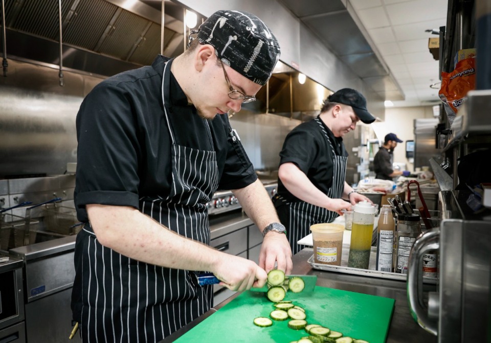 <strong>Line cook Dalton Cresswell preps food at The Farms at Bailey Station, which offers its residents access to five dining venues. </strong>(Mark Weber/The Daily Memphian)