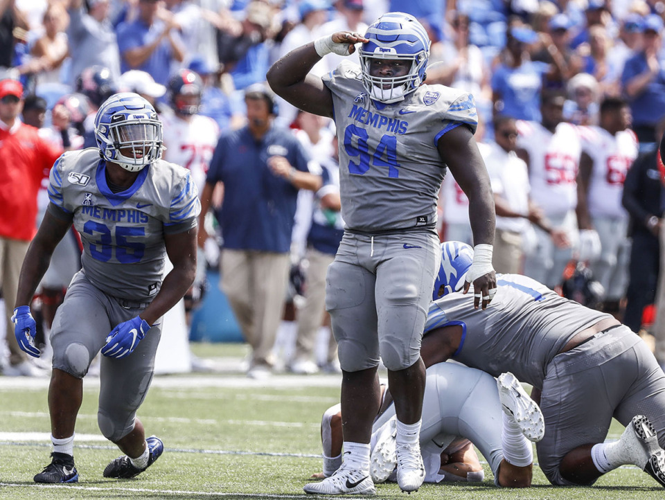 <strong>Memphis defensive linemen Joseph Dorceus, middle, celebrates an tackle against Ole Miss durin their NCAA football game at the Liberty Bowl Memorial Stadium Aug. 31, 2019.</strong> (Mark Weber/The Daily Memphian file)