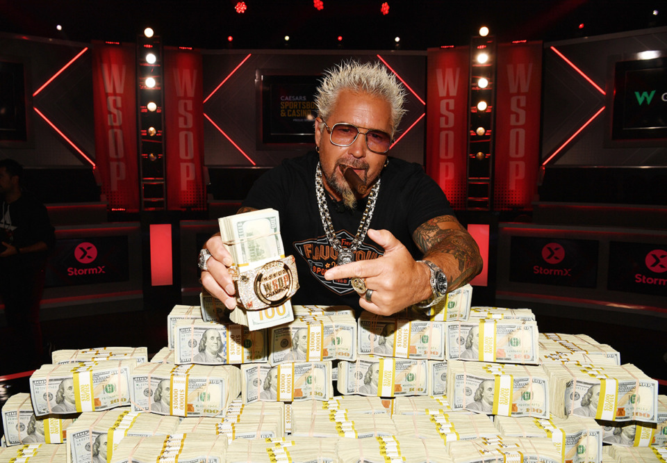 <strong>Guy Fieri poses with the 2023 World Series Of Poker Main Event Bracelet and Stack of Cash at Horseshoe Las Vegas July 7 in Las Vegas.</strong> (Denise Truscello/Getty Images for Caesars Entertainment)