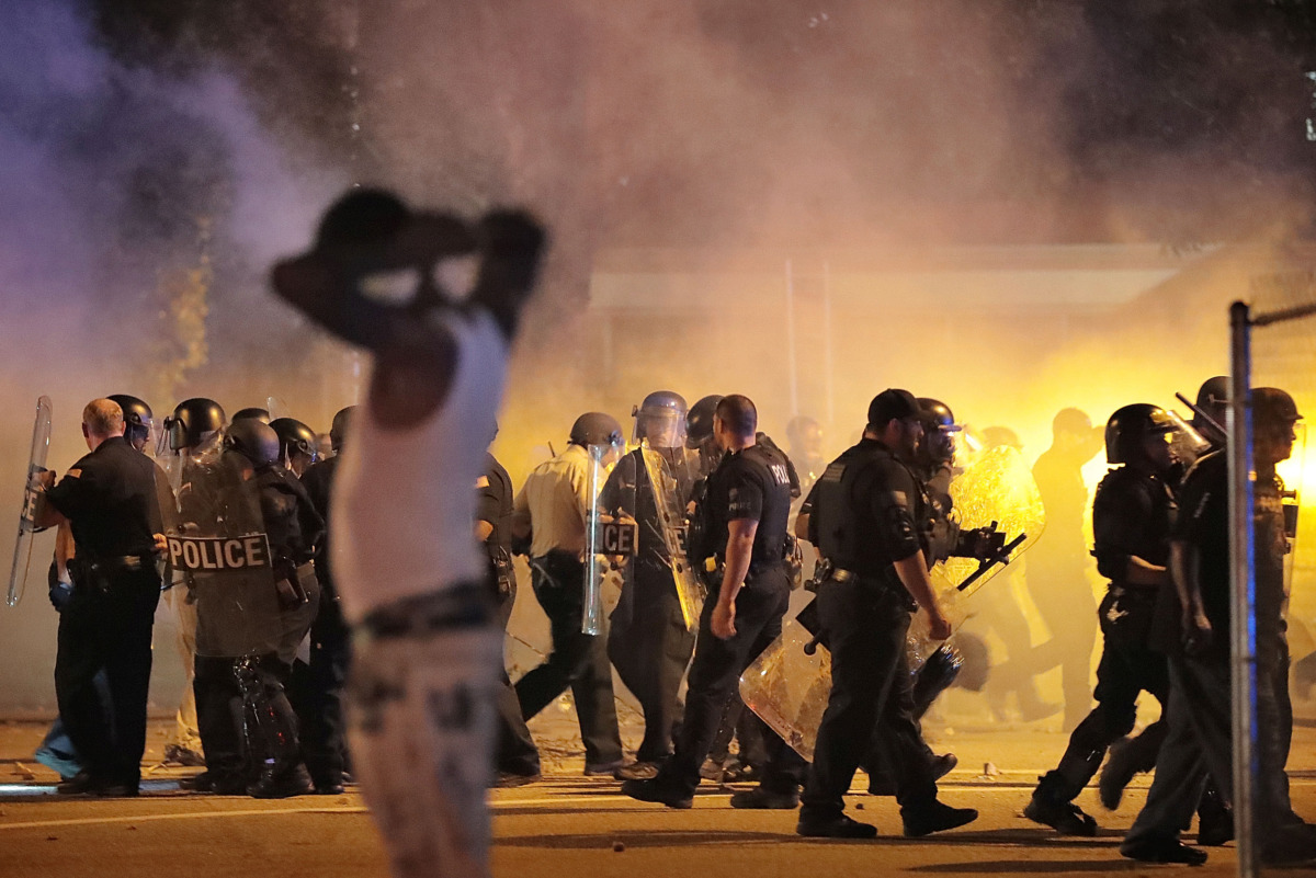 <strong>Police retreat under a cloud of tear gas as protesters diperse from the scene of a standoff after Frayser residents took to the streets in anger over the shooting of a youth&nbsp; earlier Wednesday. Dozens of protesters clashed with police, throwing stones and tree limbs until police forces broke up the angry crowds with tear gas.</strong> (Jim Weber/Daily Memphian)