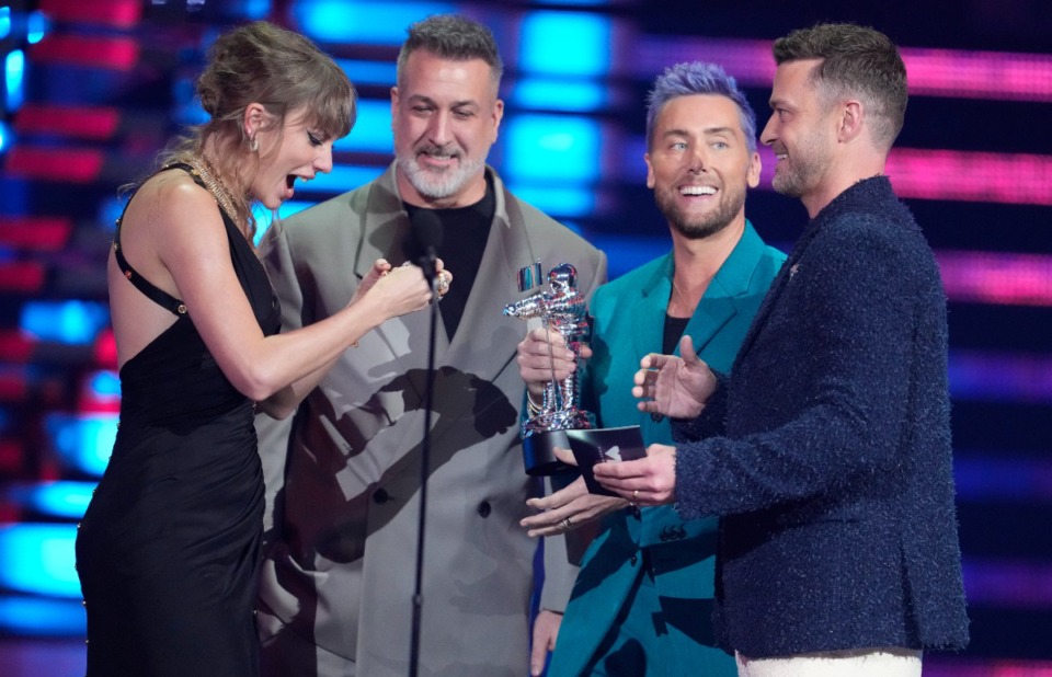 <strong>From center: Joey Fatone, Lance Bass, and Justin Timberlake of NSYNC present the award for best pop to Taylor Swift, far left, for "Anti-Hero" during the MTV Video Music Awards Sept. 12 at the Prudential Center in Newark, N.J.</strong> (Charles Sykes/Invision/AP file)