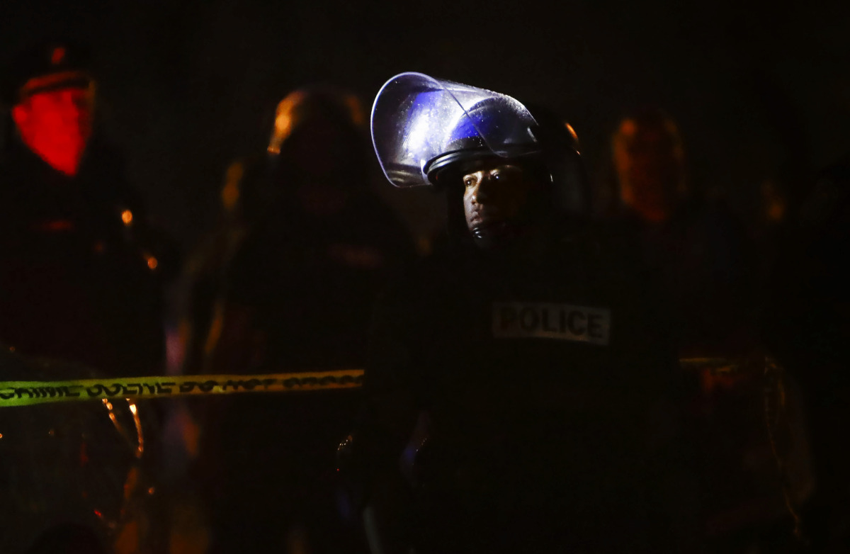 <strong>Memphis police maintain a perimeter around the crime scene after protesters took to the streets of Frayser in anger over the shooting of a youth by U.S. Marshals earlier Wednesday. Dozens of protesters clashed with police, throwing stones and tree limbs until police forces broke up the angry crowd with tear gas.</strong> (Mark Weber/Daily Memphian)
