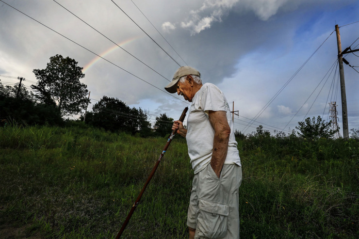 <strong>As a rainbow dawns the evening skies, Nonconnah Creek Conservancy member Gene McKenzie hikes through Nash-Buckingham Park near Getwell Road July 20, 2019.</strong> (Mark Weber/The Daily Memphian file)