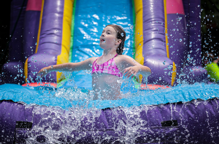 <strong>A camper slides into an inflatable bouncy pool at St. Columba's Camp Able June 7, 2022.</strong> (The Daily Memphian file)