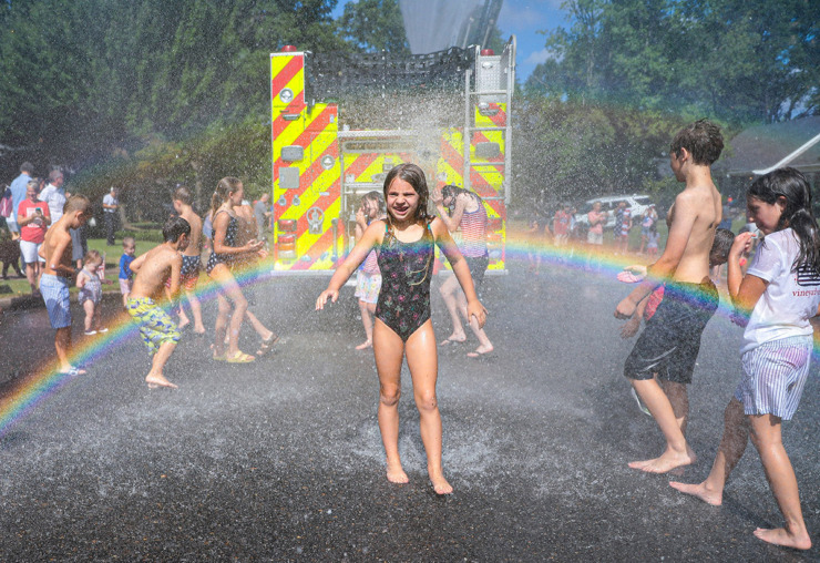 <strong>Caroline Beaver plays in the water as fire fighters hose down neighborhood kids after the 73rd annual High Point Terrace Fourth of July parade July 4, 2022.</strong> (The Daily Memphian file)