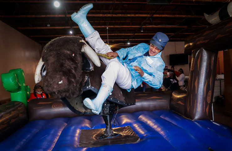 <strong>Tracy Moore tries her hand at the mechanical bull at Brinson's seventh annual New Year's Eve party Dec. 31, 2022. Brinson&rsquo;s invited people experiencing homelessness for free food, games, live performances and backpack and outerwear giveaways.</strong> (Patrick Lantrip/The Daily Memphian file)
