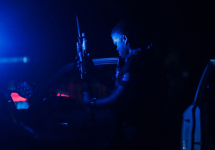 <strong>A Memphis police officer grabs his gun at a crime scene in Whitehaven after police finally cornered Ezekiel Kelly, who was accused of committing an hours-long shooting spree that left three dead and six wounded at multiple locations across the city Sept. 7, 2022.</strong> (Patrick Lantrip/The Daily Memphian file)