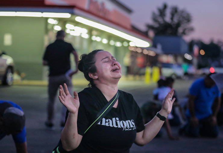 <strong>Dozen of mourners from the Nutbush neighborhood gathered to pray and mourn outside of the AutoZone parking lot Sept. 8, 2022. A man was shot there during a citywide shooting spree that left three dead and six wounded the night before.</strong> (Patrick Lantrip/The Daily Memphian file)