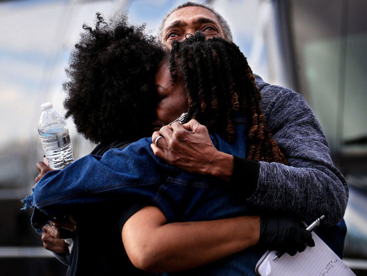 <strong>A Memphis police officer hugs the family of rapper Young Dolph after he was killed outside of a store Nov. 17, 2021.</strong> (Patrick Lantrip/The Daily Memphian file)