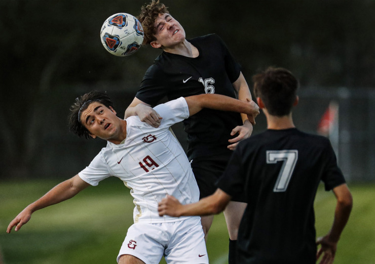 <strong>St. George&rsquo;s Independent School midfielder Diego Guerra (bottom) battles Houston High School defender Cage Warmth (top) for a loose ball on Tuesday, March 23, 2021.</strong> (Mark Weber/The Daily Memphian file)