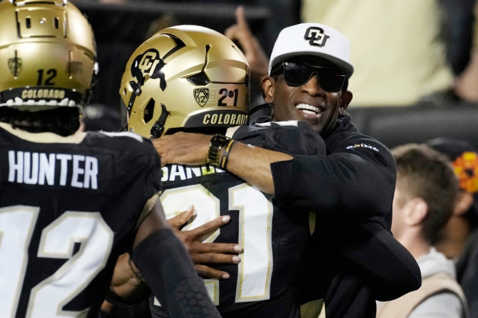 <strong>Colorado head coach Deion Sanders, right, hugs his son, safety Shilo Sanders, after he returned an interception for a touchdown against Colorado State Saturday, Sept. 16, 2023, in Boulder, Colo. Sanders&nbsp;Colorado football coach Deion Sanders is the biggest story in college football. The City of Memphis is paying close attention. Coach Sanders is the biggest story in college football and television ratings indicate a lot of Memphians are watching.</strong> (AP File Photo/David Zalubowski)