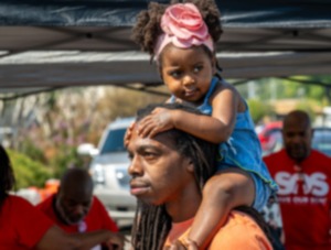 <strong>Jesse Watkins and his daughter, Gizelle Watkins, watch the Whitehaven High School band at the MEMfix fesiival at Southland Mall in Whitehaven, Saturday, Sept. 23, 2023.</strong> (Greg Campbell/Special for The Daily Memphian)