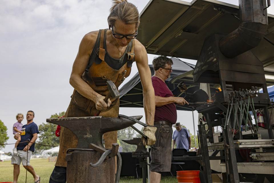 <strong>Memphis Metal Museum blacksmith Jami Honey crafts iron during the Pink Palace Crafts Fair in East Memphis on Sunday, Sept. 24, 2023.</strong> (Ziggy Mack/Special to The Daily Memphian)