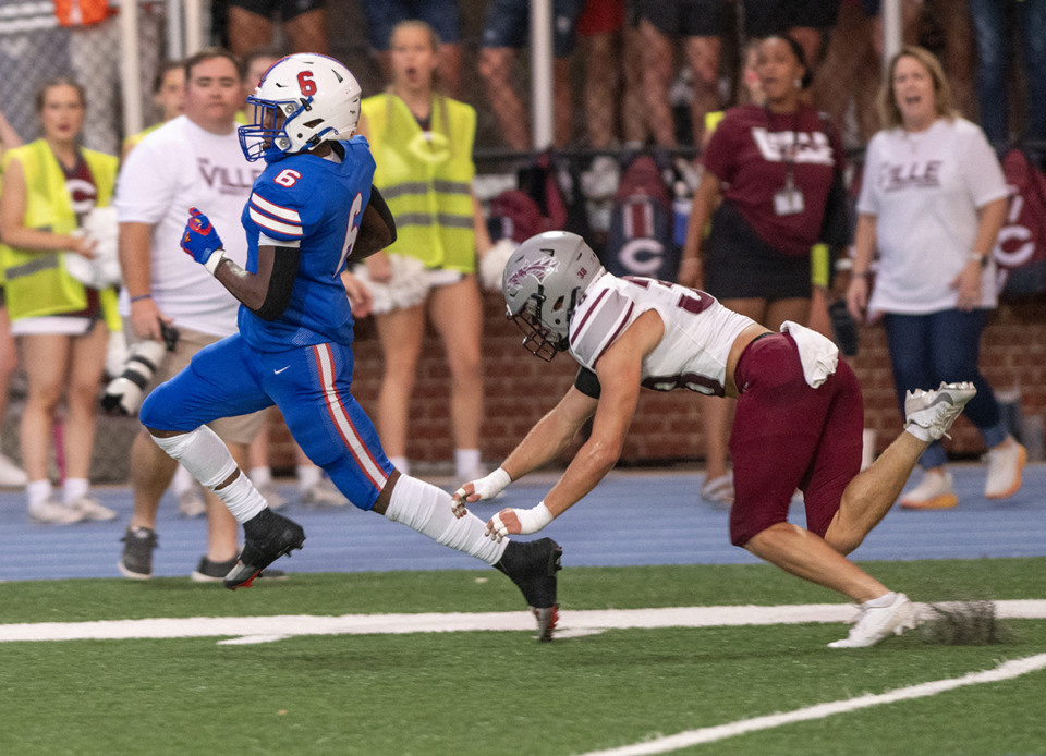 <strong>Geron Johnson sprints to the goal line with Collierville's Joseph Myers makes an effort to stop him in the Class 6A, Region 8 contest at Bartlett High School Sept. 1.</strong> (Greg Campbell/Special to The Daily Memphian)