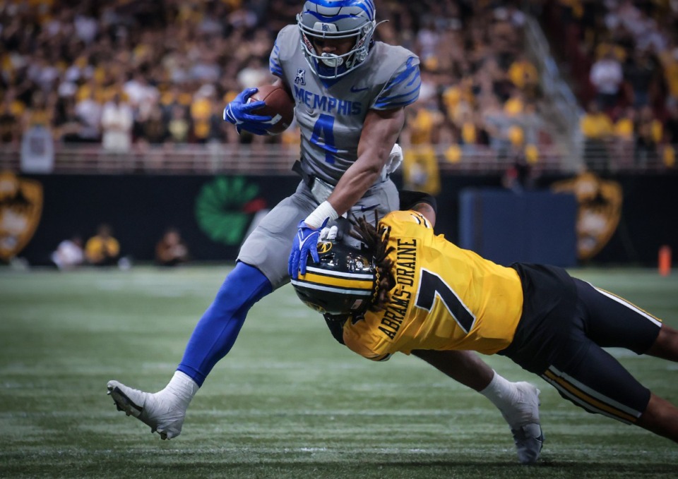 <strong>University of Memphis running back Blake Watson (4) stiff-arms a defender during a Sept. 23, 2023 game against the University of Missouri in St. Louis.</strong> (Patrick Lantrip/The Daily Memphian)