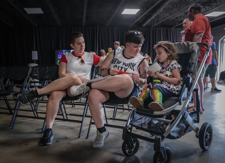 <strong>Be and Catelyn Stone do crafts with their daughter, Parker, while waiting for a short film to start at Opera Memphis' location on Cooper Street Sept. 30, 2023.</strong> (Patrick Lantrip/The Daily Memphian)