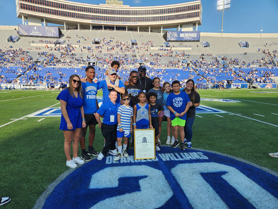 <strong>Former Memphis running back DeAngelo Williams (center in Tigers T-shirt and sunglasses) is honored on the field at Simmons Bank Liberty Stadium during halftime of a Saturday, Sept. 30, 2023, game against Boise State.</strong> (Frank Bonner II/The Daily Memphian)