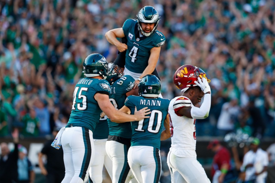 <strong>Philadelphia Eagles place kicker Jake Elliott (4) is lifted by offensive tackle Jordan Mailata (68) after kicking the game winning field goal in overtime to defeat the Washington Commanders 34-31 during an NFL football game, Sunday, Oct. 1, 2023, in Philadelphia.</strong> (AP Photo/Rich Schultz)