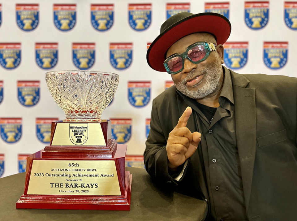 <strong>James Alexander of the Bar-Kays poses with the AutoZone Liberty Bowl&rsquo;s Outstanding Achievement Award, which will be presented to the Bar-Kays Dec. 28.</strong> (Courtesy AutoZone Liberty Bowl)