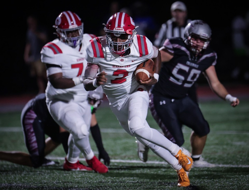 <strong>Germantown quarterback Cordero Walker (2) runs past several defenders during a Sept. 22, 2023 game against Collierville.</strong> (Patrick Lantrip/The Daily Memphian)