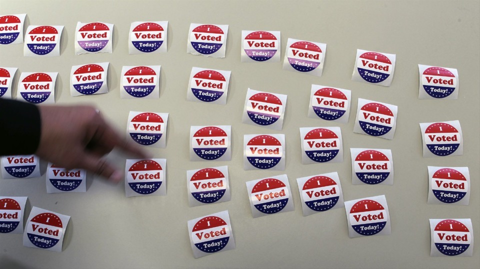 <strong>Election worker Gwen Ware put out vote stickers at the Shelby County Election Commission Downtown.</strong> (The Daily Memphian file)