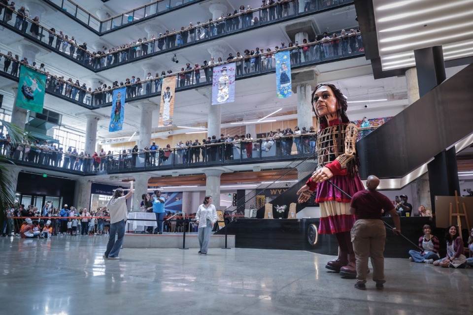 <strong>Little Amal, 12-foot puppet of a 10-year-old Syrian refugee child, enters the Crosstown Concourse during a visit to Memphis Oct. 4, 2023.</strong> (Patrick Lantrip/The Daily Memphian)